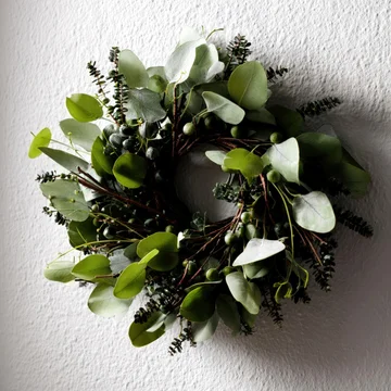 Clean Nordic holiday wreath on bright wall