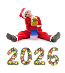 Boy Dressed as Santa Claus Holding Gift Box Beside Christmas New Year 2026 Evergreen Branch Number Decoration on a white background