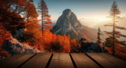 Autumn mountain landscape with dramatic peak and wooden deck foreground