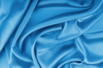 Crumpled, wrinkled cyan colored glossy silk satin with wave drapery.. Shiny smooth fabric with soft...