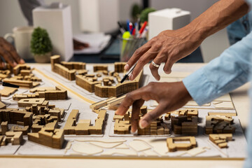 Real estate team using 3D models to explore construction layout options, working on residential...
