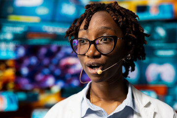 Close up of female scientist talking in mic during presentation, reviewing CT scans and MRI data analytics. African american healthcare expert in medical research lab showing health data to audience
