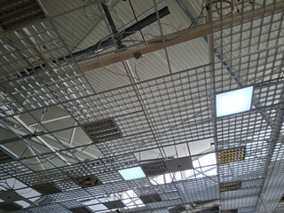 Fototapeta premium Ceiling in a shopping center with ventilators and electric lamps