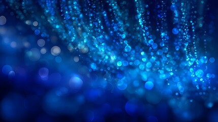 Abstract blue background with glittering lights and magical bokeh effect creating a beautiful festive pattern