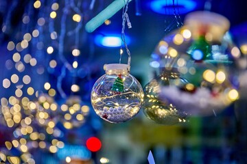 Christmas light decorations with bokeh effect, showcasing glass ornaments filled with festive elements, creating a warm and inviting holiday atmosphere with copy space