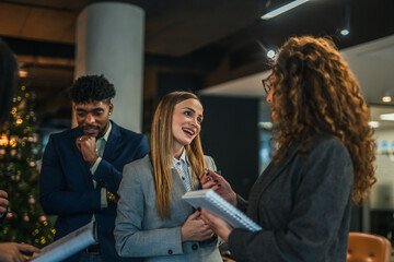 Diverse business team collaborating during office christmas party