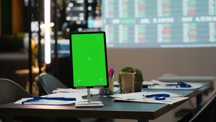 Empty copy space on device in the boardroom with charts on projection board, business performance data for late night strategic planning and report analysis. Corporate development.