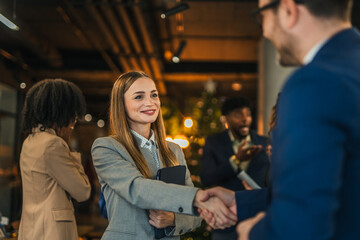 Business people shaking hands celebrating partnership in casual office