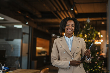Happy smiling businesswoman in office during christmas holiday