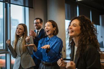Business team celebrating victory and success in a modern office