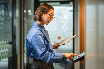 Businesswoman accessing secure office system with touchscreen technology