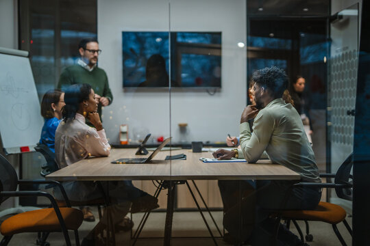 Diverse business team collaborating during a corporate meeting - Powered by Adobe