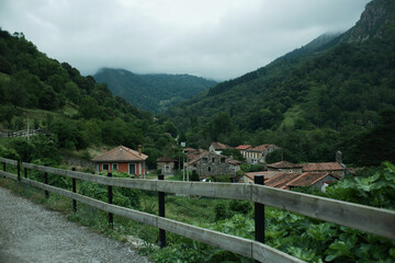 Scenic hiking trail with a view of a traditional small village in Northern Spain. Senda del Oso, Asturias