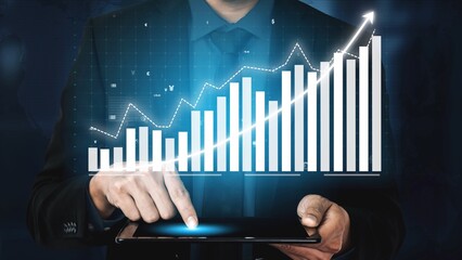 A business professional engages with digital financial data on a tablet, showcasing a vibrant graph that symbolizes growth and success in investments and analytics. Copula