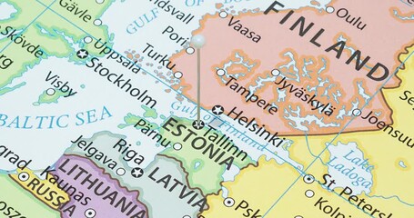 A zoom out of a white pin into tallinn city of estonia political map