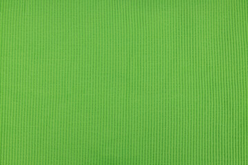 Bright green ribbed knitted fabric texture background