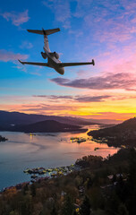 Private Jet Over City Skyline at Sunset: Airplane Flight Over Burnaby, BC, Canada