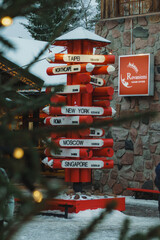 Iconic Red Signpost (Pencil-Shaped) with White Directional Signs to Global Cities in Santa Claus Village, Lapland