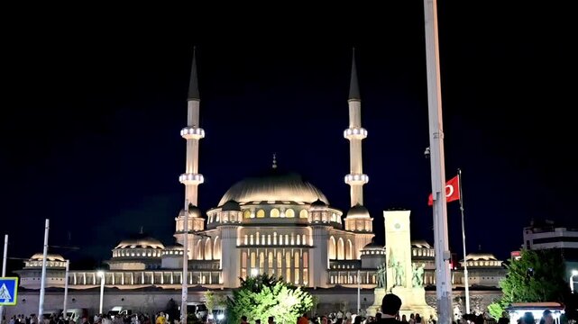Istanbul, Turkey, August 1, 2025. Slow-motion nighttime footage of Taksim Square. The New Taksim Mosque, illuminated by night lights, dominates the square. City life and tourist attractions.