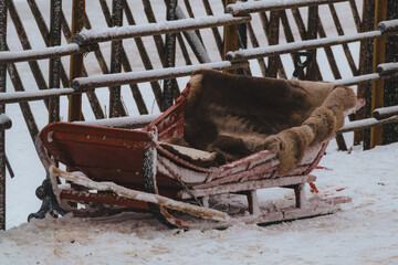 Traditional Wooden S&aacute;mi Sleigh (Pulkka) Resting in Snow-Covered Nordic Winter Landscape