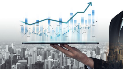 A professional hand holds a tablet displaying statistical graphs and charts, symbolizing business growth and success against a city skyline backdrop. Scalp