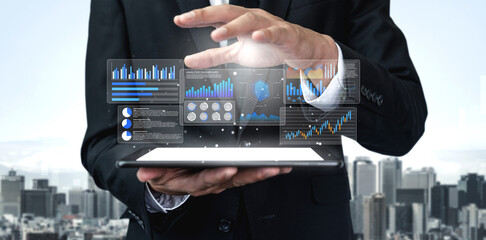 A business professional showcases digital charts and graphs on a tablet, illustrating financial data analysis with a dynamic cityscape in the background. Gantry