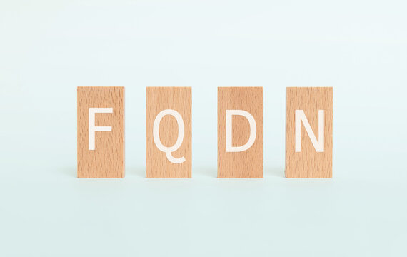 There is wood block with the word FQDN. It is an abbreviation for Fully Qualified Domain Name as eye-catching image.