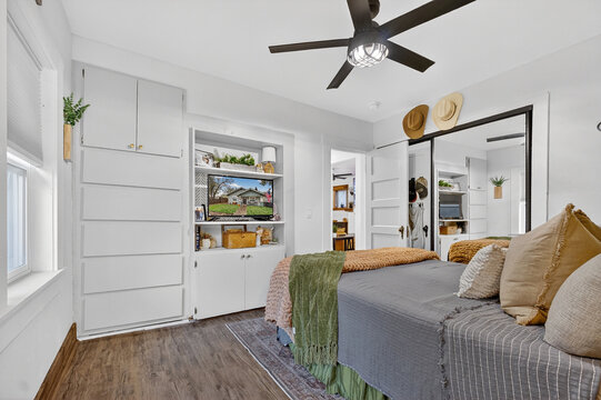 bright minimalist retreat, elegant bedroom featuring ample natural illumination and organized storage