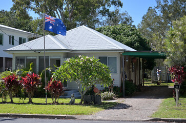 Astralia's national flag fly above Australian home
