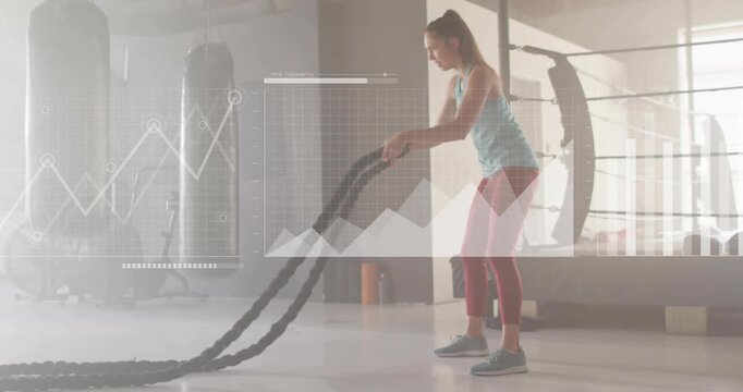 Woman gripping and swinging battle ropes, ramping amplitude while analytics charting metrics, map