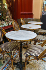 Elegant Cafe Scene with Marble Tables and Rattan Chairs on a Detailed Mosaic Tiled Floor