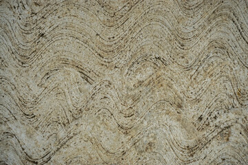 Rough textured concrete surface with dark wavy lines for abstract background