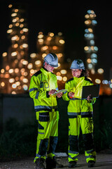 Empowering the future of energy with smart industrial solutions. Dedicated experts ensuring safety and efficiency in global sustainable power generation. Two industrial engineers wearing safety gear.