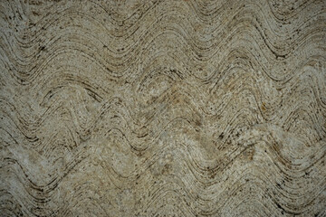 Rough textured concrete surface with dark wavy lines for abstract background