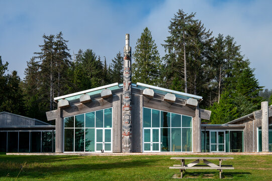 Skidegate, B.C., Canada &ndash; Sept. 2025: Front view of the Haida Heritage Centre at Kay Llnagaay with a carved monument pole and cedar architecture.
