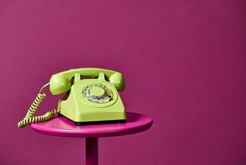 Vintage Green Telephone in Retro Style: Bright Colors and Playful Aesthetics on Pink Background for Quirky 1960s Interior Design Decor