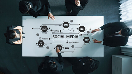 A diverse business team engages in a collaborative meeting focused on social media marketing strategies in a modern office setting, emphasizing networking and digital presence. Amity