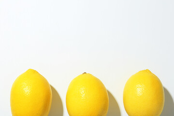 Fresh ripe lemons on white background, flat lay. Space for text