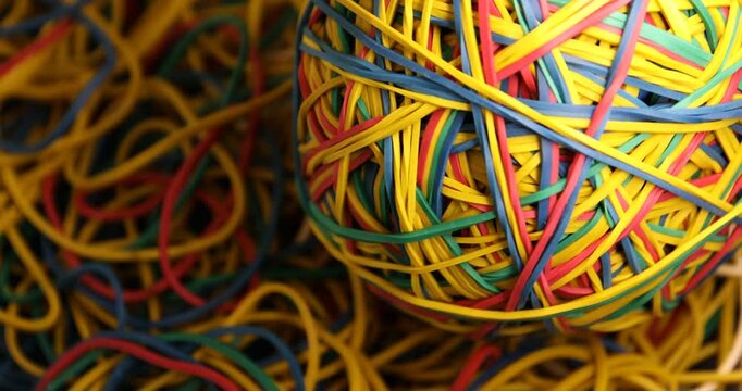 Closeup view of many colorful rubber bands as background, spinning