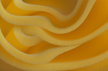 sheets of dark yellow or orange foam sponge material. folded industrial material