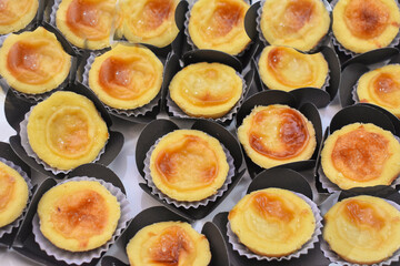 Trays filled with Brazilian sweets: brigadeiro, tortelete, and grape surprise, along with savory snacks with tomatoes.