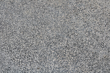 Full-frame, uniform texture of a dark grey and light grey speckled surface, resembling granite, terrazzo, or aggregate concrete.