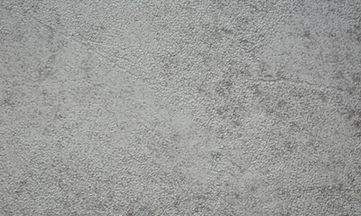 A close-up of a fragment of roughly applied gray plaster.