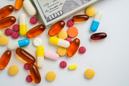 Medicine prescription drugs cost concept, Pills on money dollars, healthcare expenses