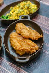 Traditional Indonesian fried banana, served in a small pan. Crispy golden batter and rustic background, ideal for Asian food, street cuisine, and culinary culture visuals