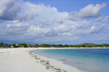 Beautiful Tropical White Sand Beach Landscape with Clear Blue Ocean Water and Cloudy Sky on the Equator Line
