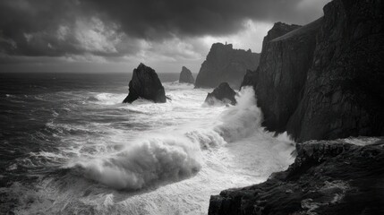 Dramatic monochrome seascape with crashing waves against rugged cliffs under stormy skies