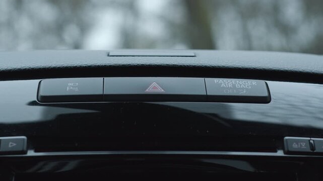 Car hazard warning button blinking with emergency flasher sound in modern interior