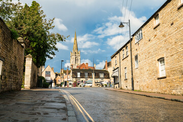 Obraz premium Castle Dyke road overlooking archtecture of Stamford town and tower of All Saints Church. England
