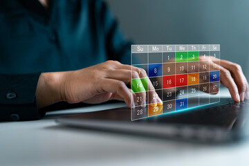 Hands typing on laptop with virtual digital calendar interface, symbolizing online schedule planning, time management, productivity and organizing tasks through technology tools.